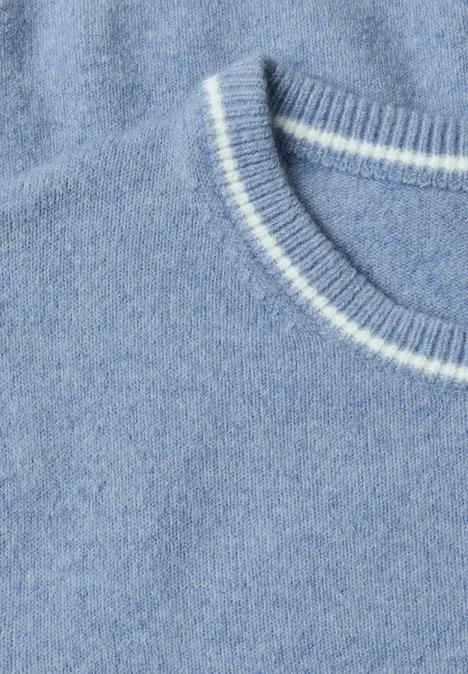 Pull à manches courtes avec détails contrastés northern blue mel. Nahaufnahme eines hellblauen Strickpullovers mit weißem Streifen am Rundhalsausschnitt.