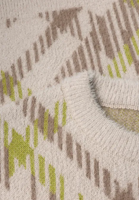 Gros plan d'un textile beige à rayures diagonales marron et vertes avec une boucle ronde en relief.