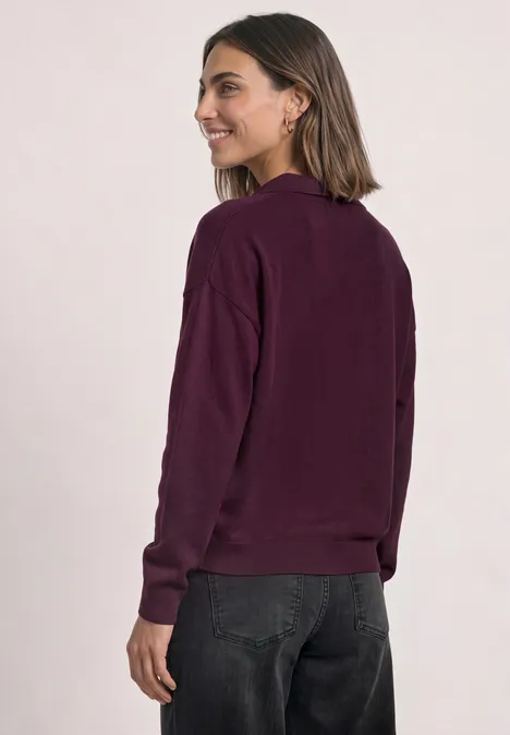 Langarm Pullover mit Polokragen berry maroon Junge Frau im Seitenprofil trägt lässiges bordeauxrotes Langarmshirt und dunkle Hose.