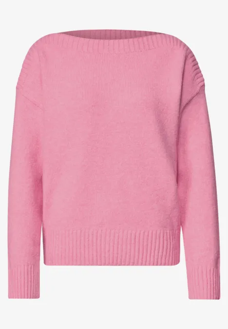 Ein pinker Langarm-Pullover aus Strick.