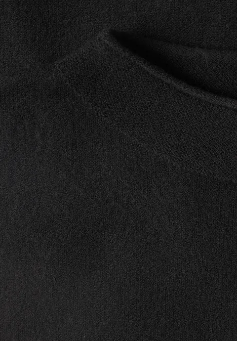 Nahaufnahme eines schwarzen Fleece-Stoffs mit feiner, weicher Textur und leichten Falten.