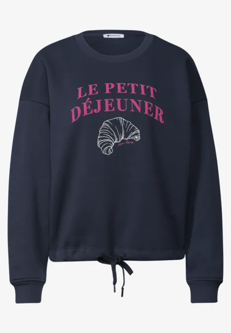 Marineblauer Sweatshirt mit rosafarbenem Schriftzug "Le Petit Déjeuner" und Croissant-Grafik, Kordelzug.