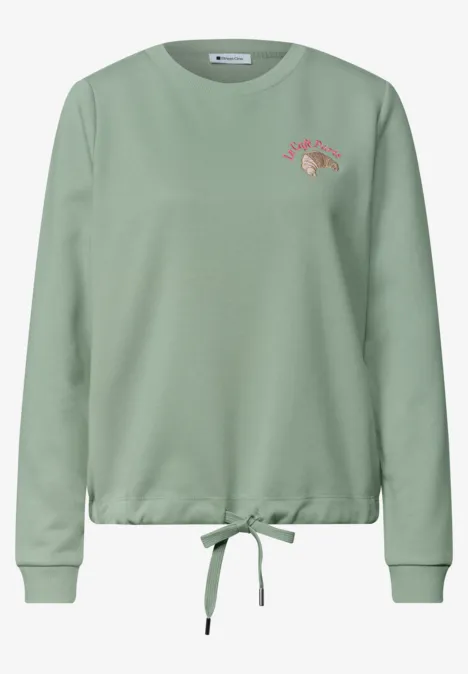 Sweatshirt met ronde hals en borduursel eucalyptus green Hellgrüner Sweatshirt-Pullover mit Rundhalsausschnitt, Kordelzug am Saum und kleinem roten Schriftzug auf der Brust.