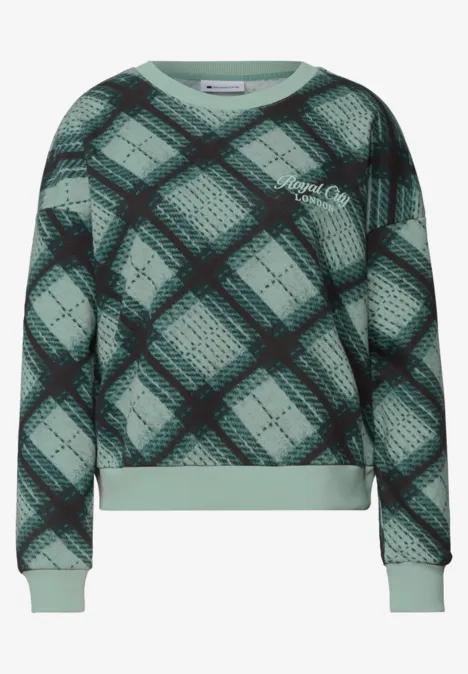 Grünes Sweatshirt mit schwarzem Karomuster, Rippbündchen an Ärmeln und Saum.