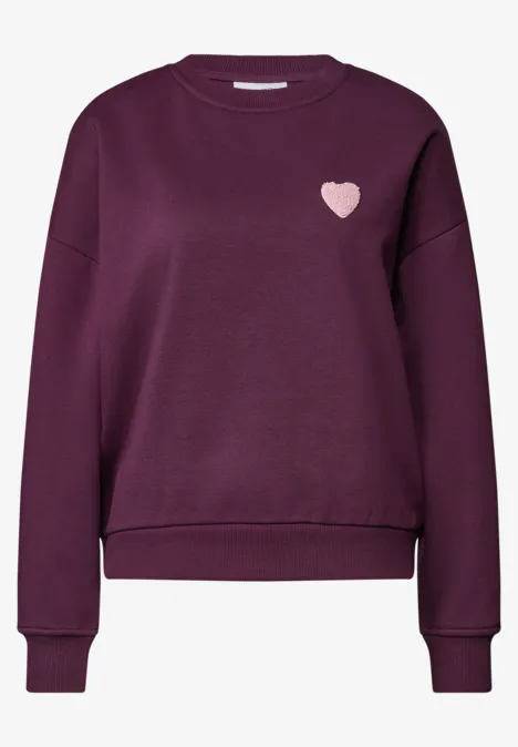 Loose Fit Sweatshirt mit Patch Detail berry maroon Dunkellila Damenpullover mit langen Ärmeln, geripptem Saum und kleinem rosa Herz-Logo auf der Brust.