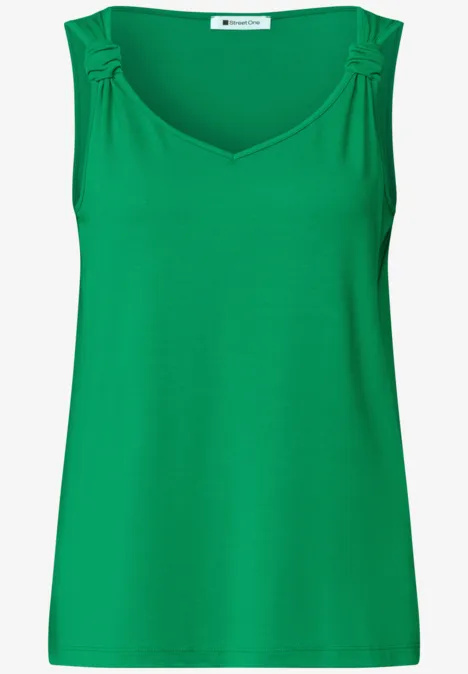 Mouwloos dames top in helder groen met V-hals en plooien op de schouders.
