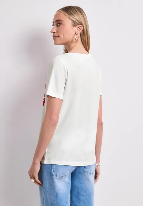 T-Shirt mit Rundhals und Print off white Frau von hinten in weißem T-Shirt und blauer Jeans vor weißem Hintergrund.
