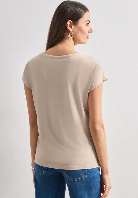 Dropped Shoulder Shirt mit Rundhals clay sand Frau von hinten in beigem Kurzarmshirt und Jeans.