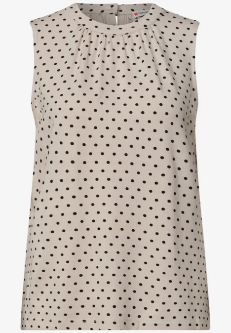 Mouwloos topje in beige met kleine zwarte stippen