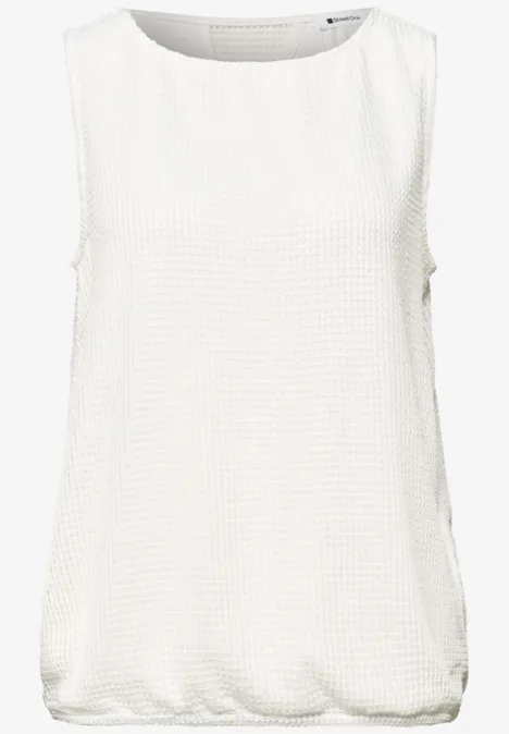 Ärmelloses, locker geschnittenes weißes Oberteil mit Rundhalsausschnitt und feiner Textur.