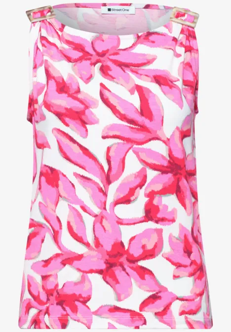 Mouwloos topje wit met groot roze bloemmotief.