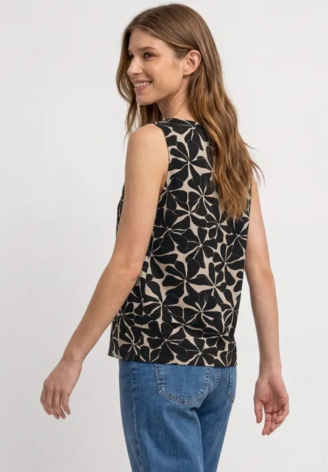Top met ronde hals en schouderdetails Black Vrouw van achteren in een blauwe spijkerbroek en een zwarte mouwloze top met wit geometrisch patroon.