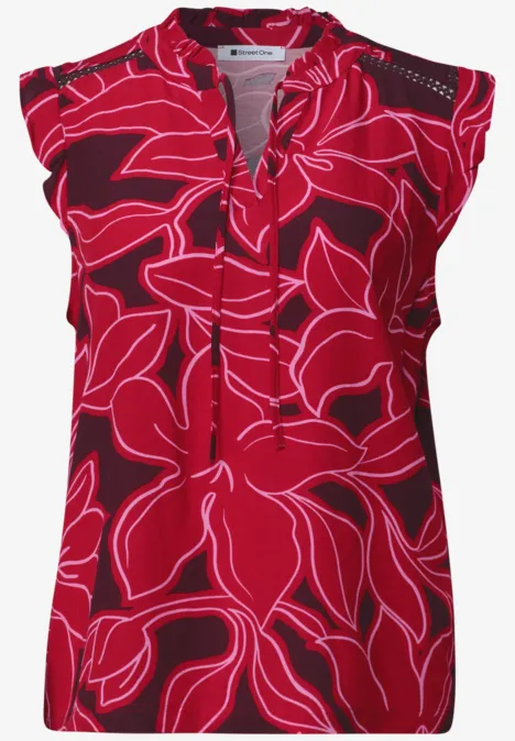 Rotes, ärmelloses Damenoberteil mit großem pinkem Blumenmuster und V-Ausschnitt.