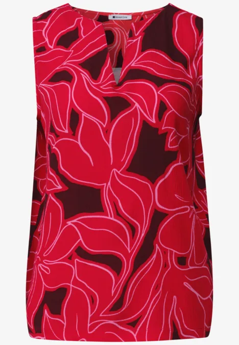 Mouwloze top met opvallende rood-roze bladprint en V-hals.
