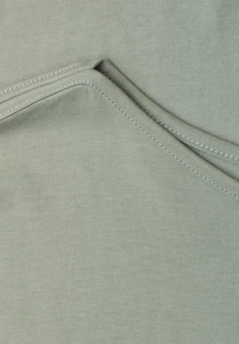 Basic Shirt mit U-Boot-Ausschnitt mint leaf Nahaufnahme eines graugrünen Stoffs mit dekorativen Nähten.