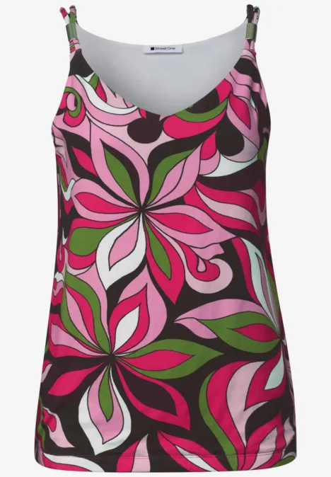 Un débardeur sans manches à motif floral abstrait rose, vert et blanc sur fond sombre.