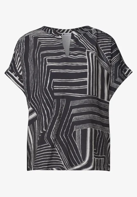 T-shirt femme noir à motif graphique blanc abstrait et fente discrète en V au col.