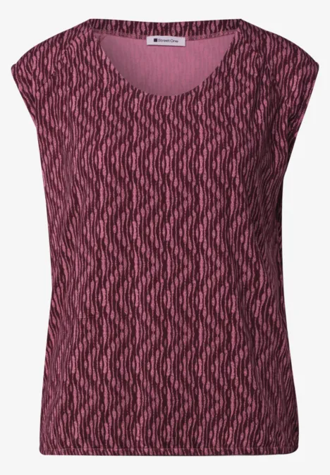 Haut sans manches rose-rouge à motif ondulé avec encolure arrondie.