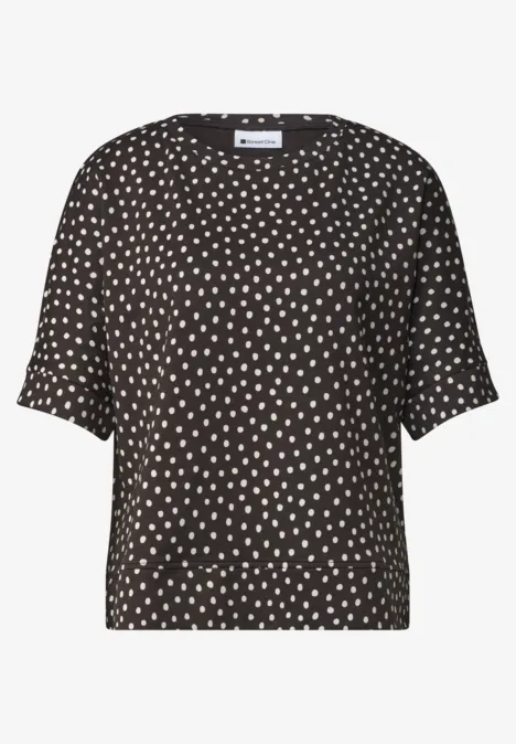 Batwing-shirt met ronde hals en print black coffee Zwarte blouse met korte mouwen en wit stippenpatroon.