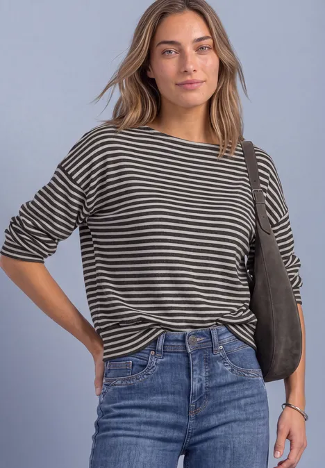 T-shirt à manches longues avec ourlet élastiqué black coffee mel. Frau im gestreiften Shirt und Jeans, lässig mit Umhängetasche posierend
