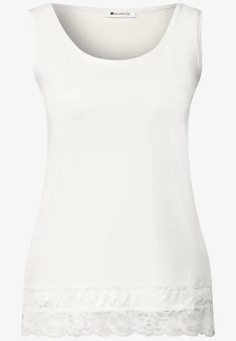 top blanc à col rond avec ourlet en dentelle