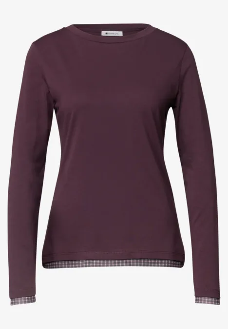 T-shirt femme à manches longues violet foncé, col rond, ourlet et poignets à motif carreaux.