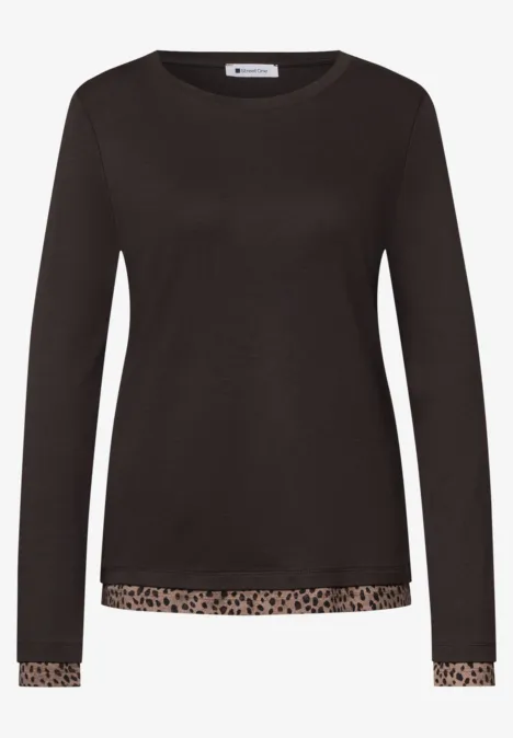 Schwarzes Langarmshirt mit Leopardenbordüre am Saum und Ärmeln.