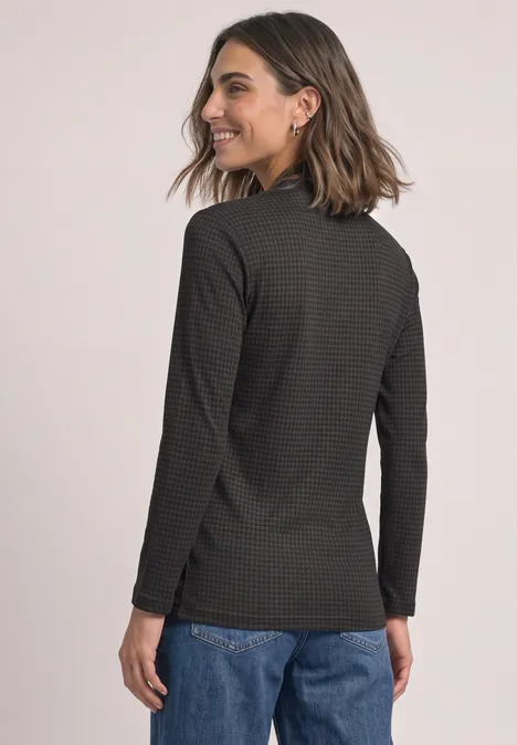 3/4-Arm Shirt mit Turtle Neck und Print black coffee Eine Frau in Jeans und schwarzem, gestreiftem Langarmshirt blickt lächelnd über die Schulter.