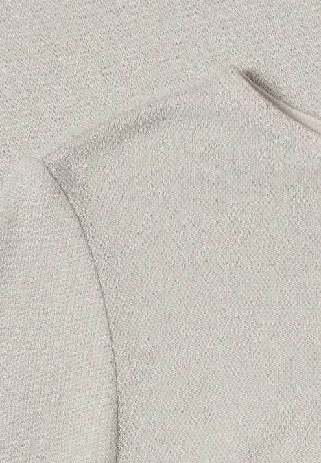 T-shirt à manches longues, col bateau et paillettes pure beige Nahaufnahme eines beigen, strukturierten Strickstoffs mit sichtbarer Naht
