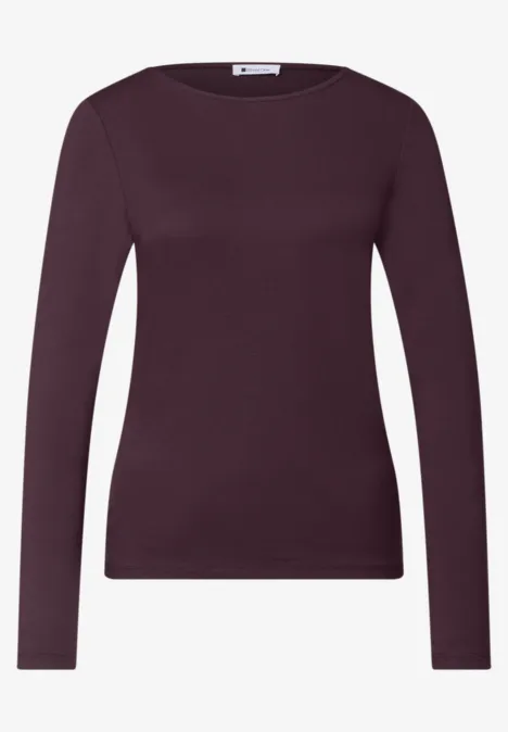 Haut femme violet à manches longues, encolure ronde et coupe ajustée.