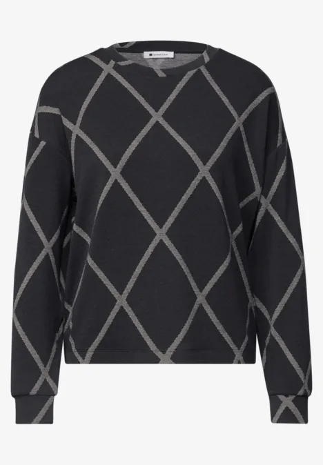Pull noir à manches longues avec un motif losange gris clair et coupe décontractée.