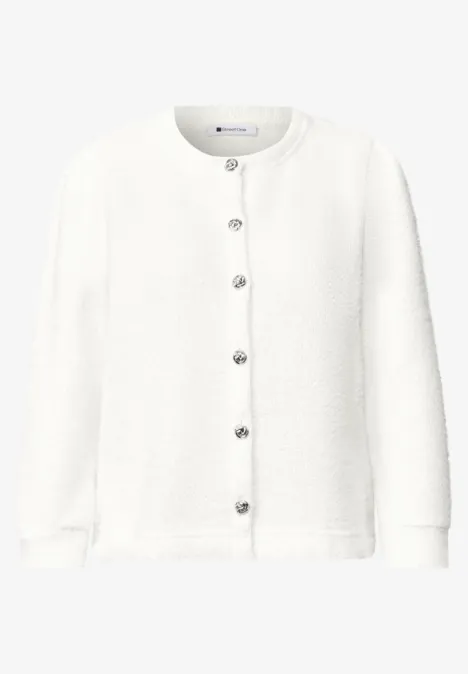 Gilet en maille blanc pour femme, col rond, manches longues et boutons argentés.