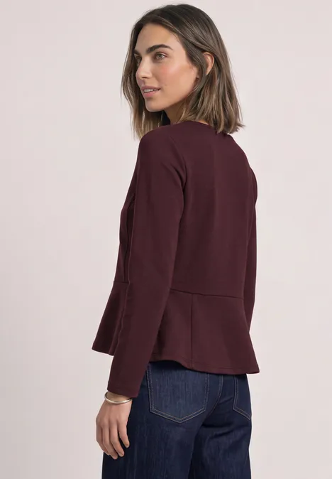 Langarm Shirt mit Volant-Saum berry plum Frau im Profil trägt einen burgunderroten Blazer und Jeans vor hellem Hintergrund.