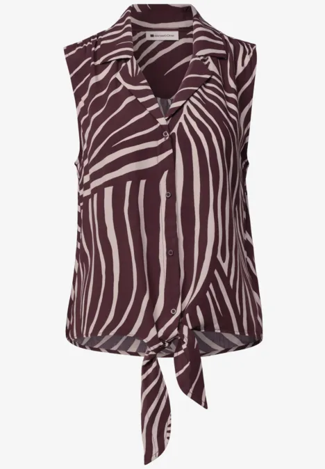 Mouwloze top met bruin-wit zebraprint en knoop aan de voorkant