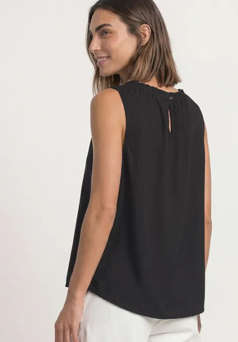 Blouse met gerimpelde ronde hals Black Frau trägt schwarzes, ärmelloses Top mit lockerem Schnitt und kleinem Rückenschlitz, lächelt zur Seite.