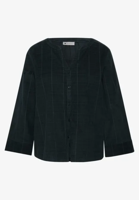 Chemise-veste vert foncé à carreaux, boutonnée, col rond et épaules légèrement tombantes.