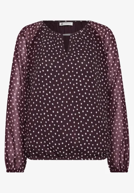 Dunkelrote Bluse mit weißen Tupfen, langen Ärmeln, V-Ausschnitt und elastischem Saum.
