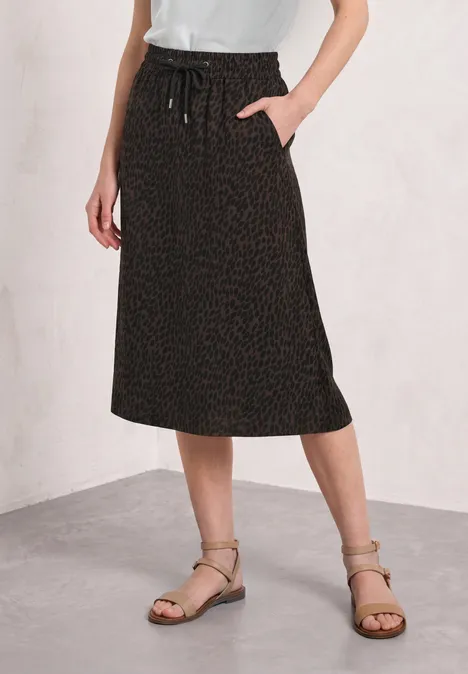 Jupe mi-longue à taille élastiquée et fentes molten earth Jupe midi noire décontractée avec cordon de taille et poches latérales.