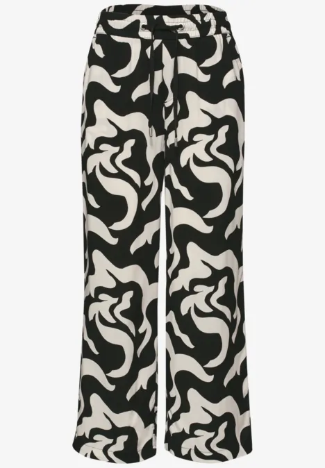 Zwart-witte broek met abstracte print en wijd vallende pijpen