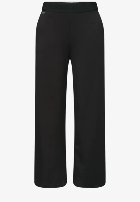 Zwarte, wijde broek met elastische tailleband.