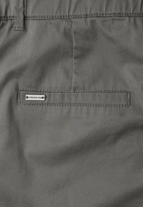 Nahaufnahme einer grauen Hose mit einer schlichten Gesäßtasche und kleinem Markenlabel.