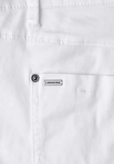 Close-up van een witte spijkerbroek met opgestikte zak, klinknagel en klein merkteken.