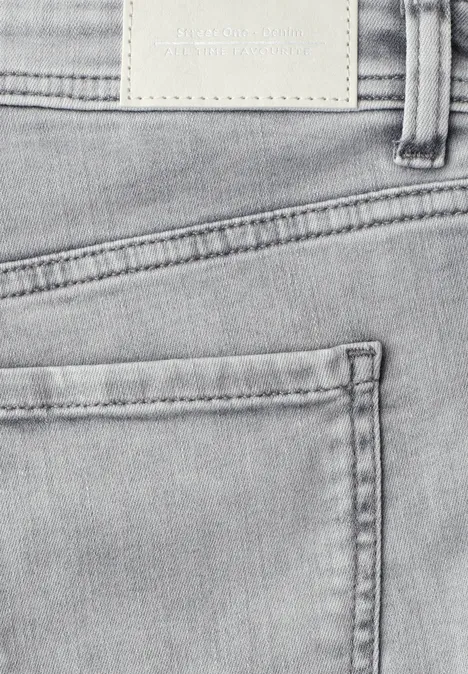 Nahaufnahme einer grauen Jeans mit sichtbarer Gesäßtasche und Label hinten am Bund.
