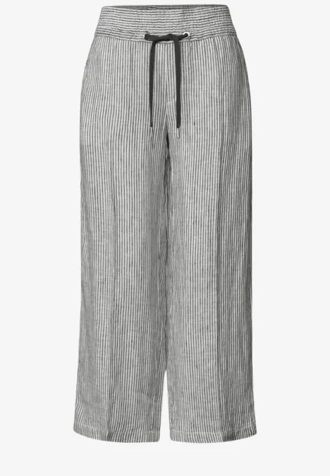 Pantalon large gris chiné en lin avec taille élastique et cordon.
