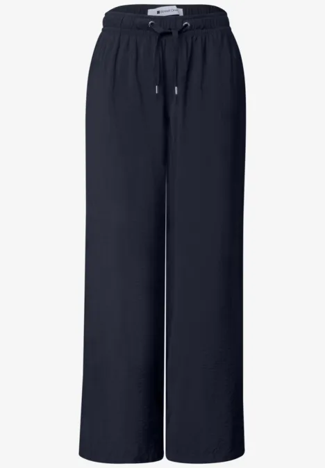 Pantalon noir ample à taille élastique avec cordon, en tissu fluide.