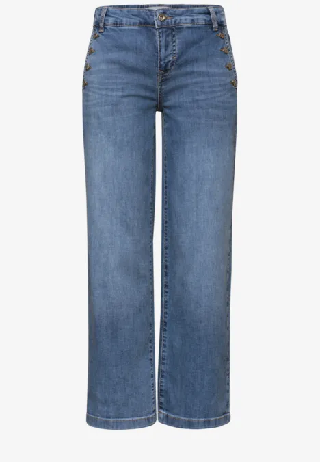 Jean bleu droit pour femme à taille haute avec boutons sur le devant.