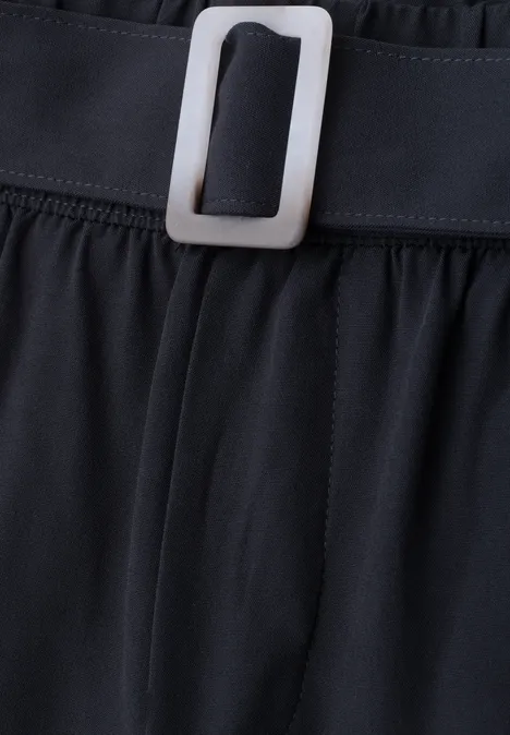 Schwarzer Stoffbund mit elegantem eckigem silbernen Gürtelverschluss in Nahaufnahme.