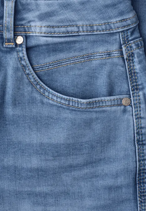 Nahaufnahme einer hellblauen Jeans mit Tasche, Naht und Metallnieten