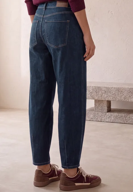 High Waist Barrel Leg Jeans im Loose Fit Dark Blue Washed Eine Person trägt dunkelblaue High-Waist-Jeans und braune Sneaker, Rückenansicht vor hellem Hintergrund.