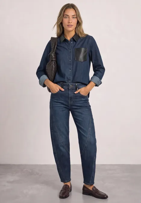 Relaxed Barrel Leg Jeans im Loose Fit Dark blue authentic washed Eine Frau trägt ein dunkelblaues Jeans-Hemd mit Lederakzenten und passende Jeans, dazu braune Loafers.